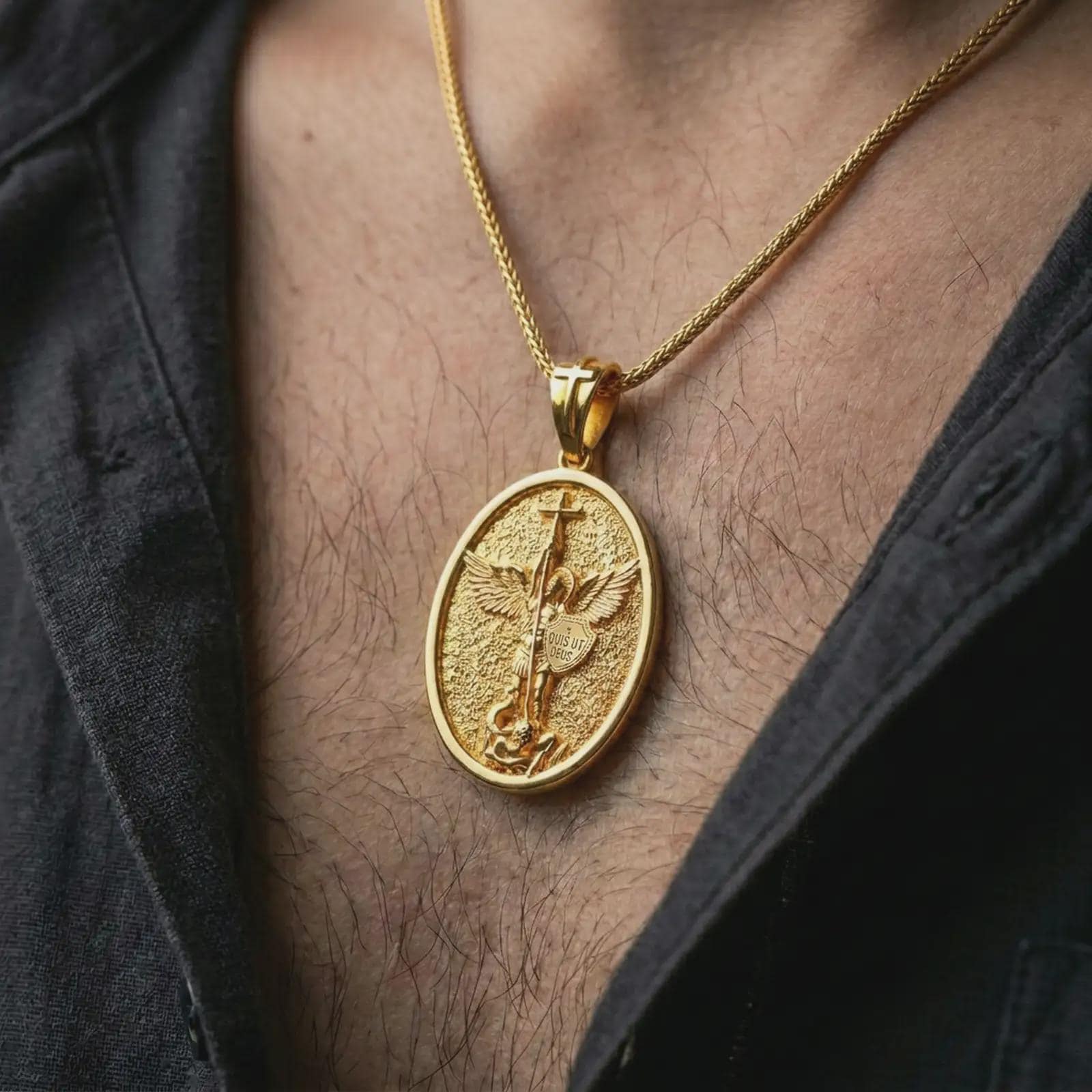 Gold plated Saint Michael pendant necklace worn on the chest, premium lifestyle jewelry photo with the protective archangel medal centered on a spiga chain.