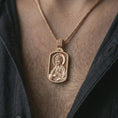 Load image into Gallery viewer, Rose gold plated Saint James the Apostle pendant necklace worn on the chest, close-up lifestyle shot featuring the sacred Saint James the Apostle design with warm rose gold tones.
