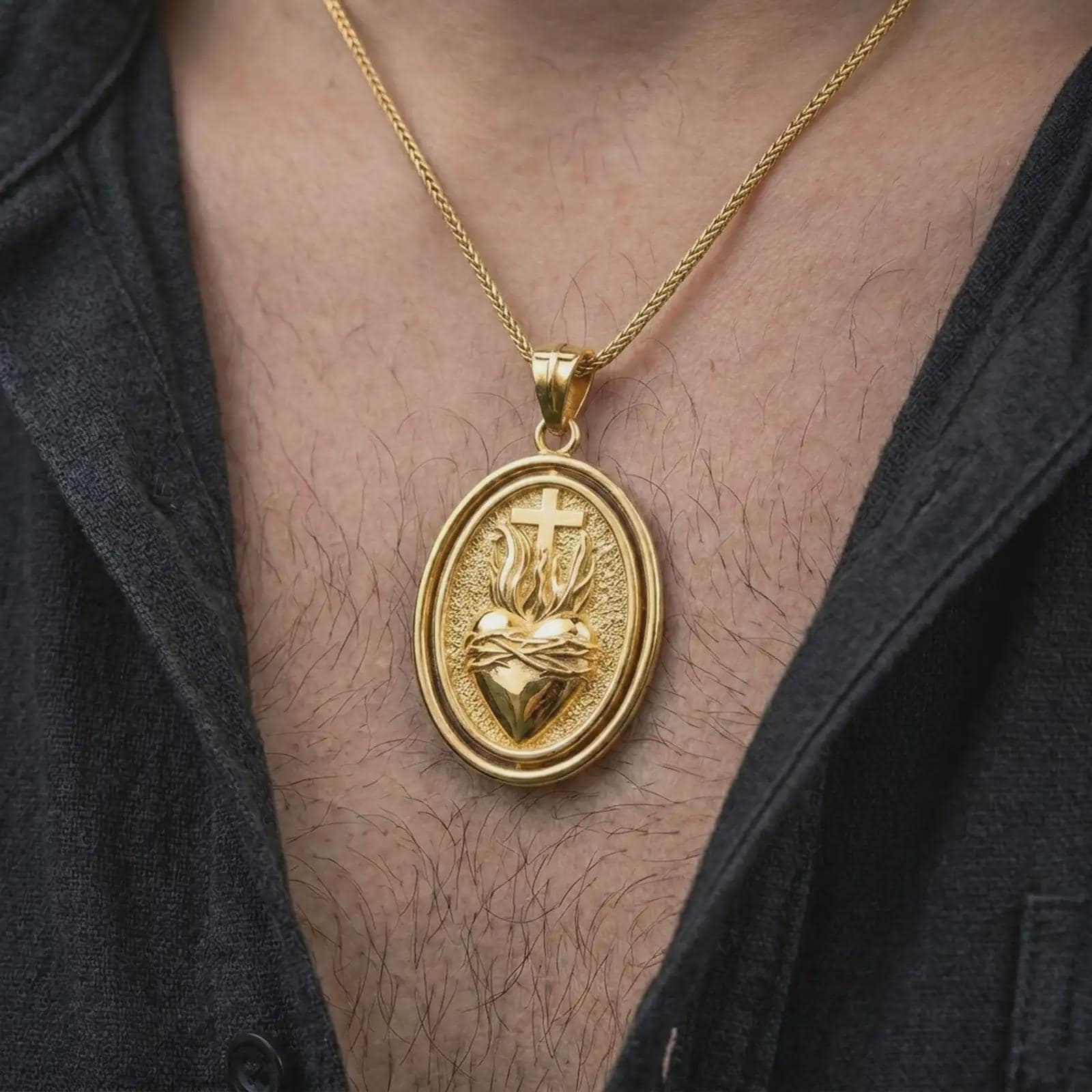 Gold plated Sacred Heart pendant necklace worn on the chest, premium lifestyle jewelry photo with the devotional Sacred Heart medal centered on a spiga chain.
