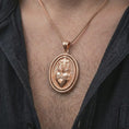 Load image into Gallery viewer, Rose gold plated Sacred Heart pendant necklace worn on the chest, close-up lifestyle shot featuring the sacred heart design with warm rose gold tones.
