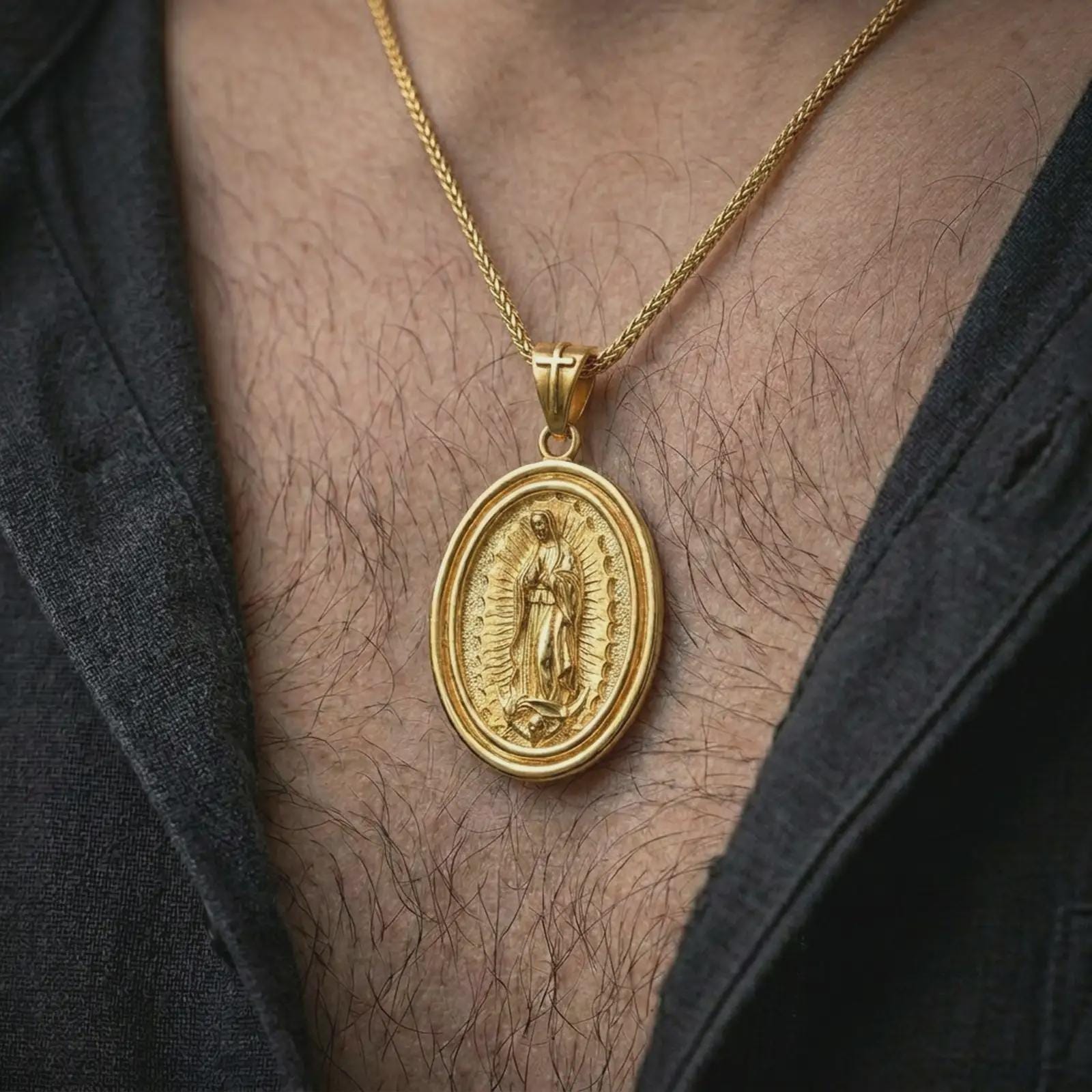 Gold plated Our Lady of Guadalupe spinner pendant necklace worn on the chest, premium lifestyle jewelry photo with the Marian spinner medal centered on a spiga chain.