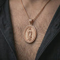 Load image into Gallery viewer, Rose gold plated Our Lady of Guadalupe spinner pendant necklace worn on the chest, close-up lifestyle shot featuring the sacred Our Lady of Guadalupe design with warm rose gold tones.
