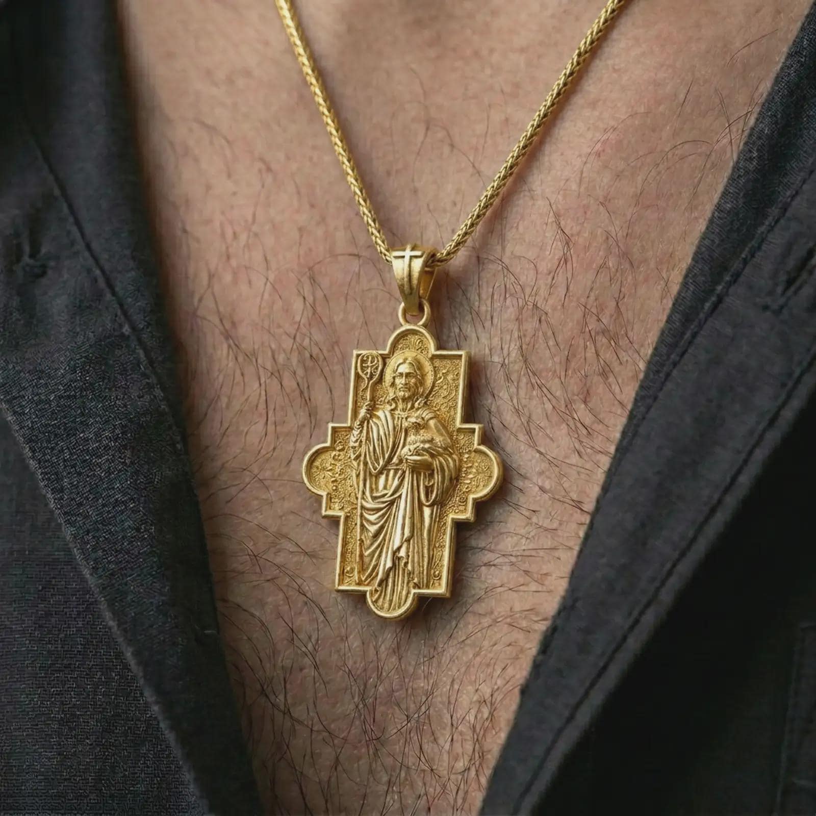 Gold plated Good Shepherd cross pendant necklace worn on the chest, premium lifestyle jewelry photo with the Good Shepherd cross pendant centered on a spiga chain.