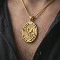 Load image into Gallery viewer, Gold plated Saint Christopher spinning pendant necklace worn on the chest, premium lifestyle jewelry photo with the protective Saint Christopher medal centered on a spiga chain.
