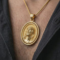 Load image into Gallery viewer, Gold plated spinning Jesus Christ pendant necklace worn on the chest, premium lifestyle jewelry photo with the rotating Jesus Christ medal centered on a spiga chain.
