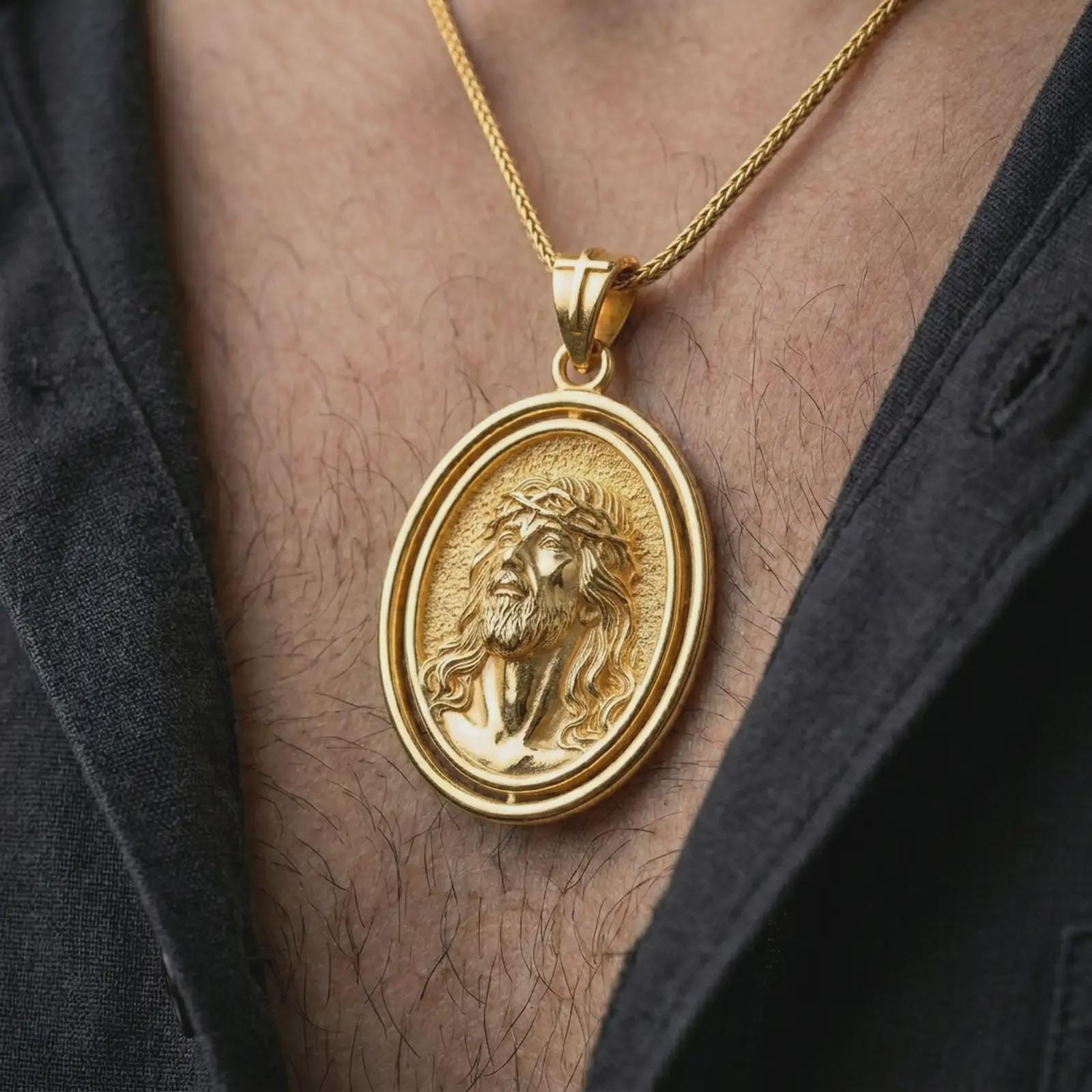 Gold plated spinning Jesus Christ pendant necklace worn on the chest, premium lifestyle jewelry photo with the rotating Jesus Christ medal centered on a spiga chain.