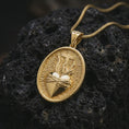 Load image into Gallery viewer, Gold plated Sacred Heart pendant necklace on textured volcanic rock, premium close-up studio composition emphasizing the flaming heart, cross, and crown of thorns symbolism.
