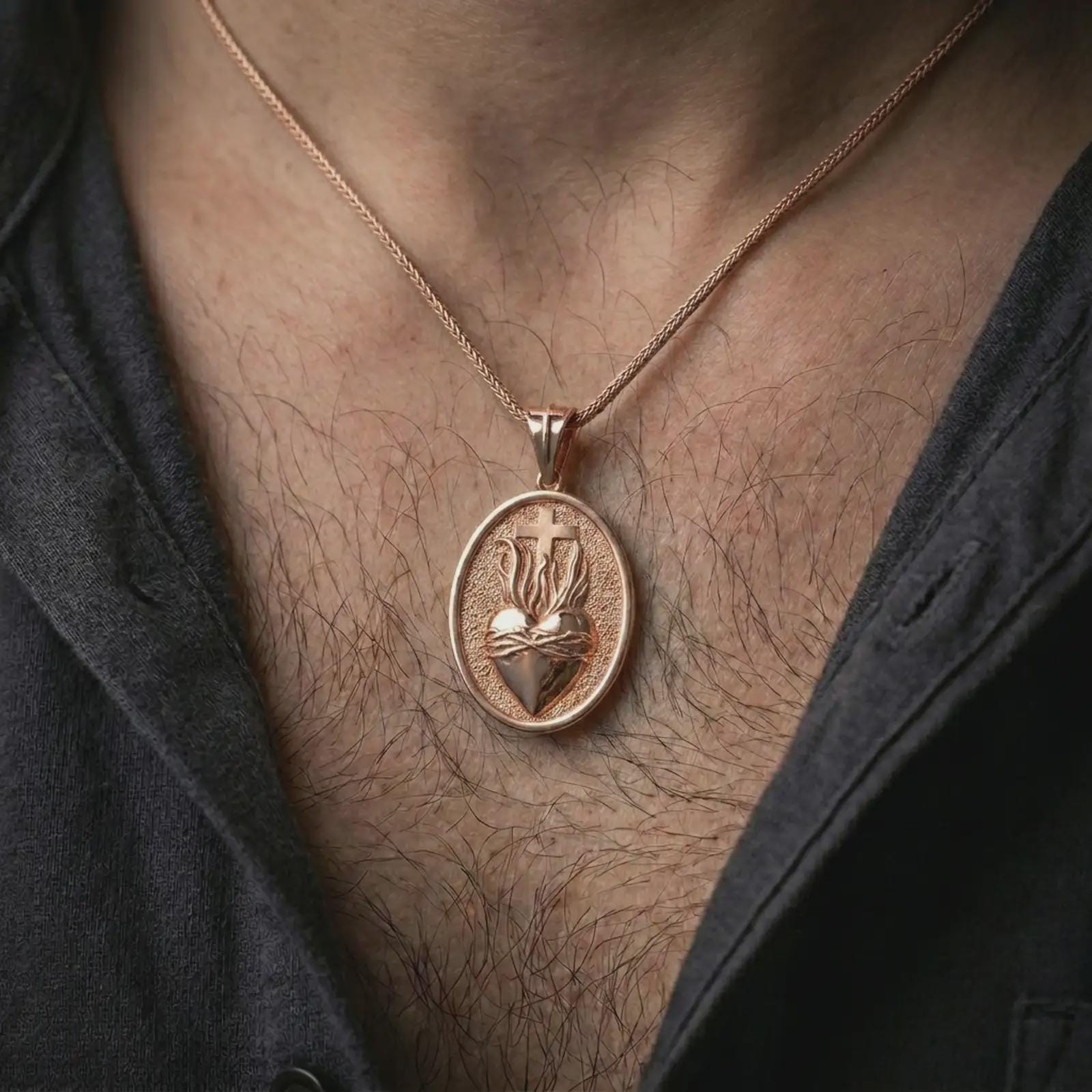 Rose gold plated Sacred Heart pendant necklace worn on the chest, close-up lifestyle shot featuring the sacred flaming heart design with warm rose gold tones.