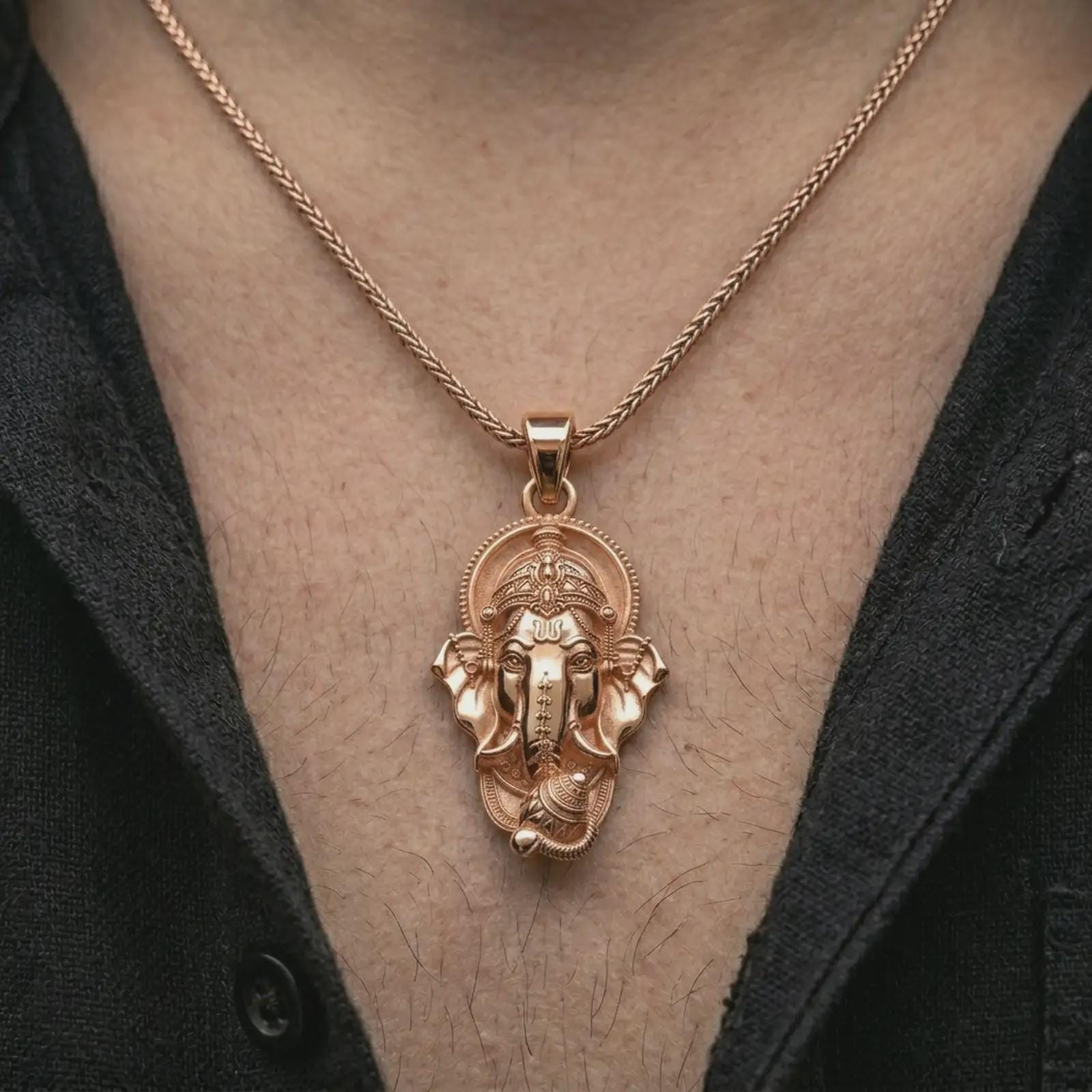 Rose gold plated Ganesha pendant necklace worn on the chest, close-up lifestyle shot featuring the sacred elephant god design with warm rose gold tones.