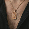 Load image into Gallery viewer, Rose gold plated Saint Roch dog tag pendant necklace worn on the chest, close-up lifestyle shot featuring the sacred Saint Roch design with warm rose gold tones.
