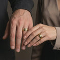 Load image into Gallery viewer, Gold plated Bushido sword band ring worn on the finger, premium lifestyle jewelry photo with the katana-inspired band clearly visible on the hand.
