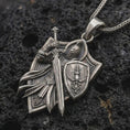 Load image into Gallery viewer, Oxidized medieval knight pendant on porous volcanic rock with deep shadows and crisp relief details.
