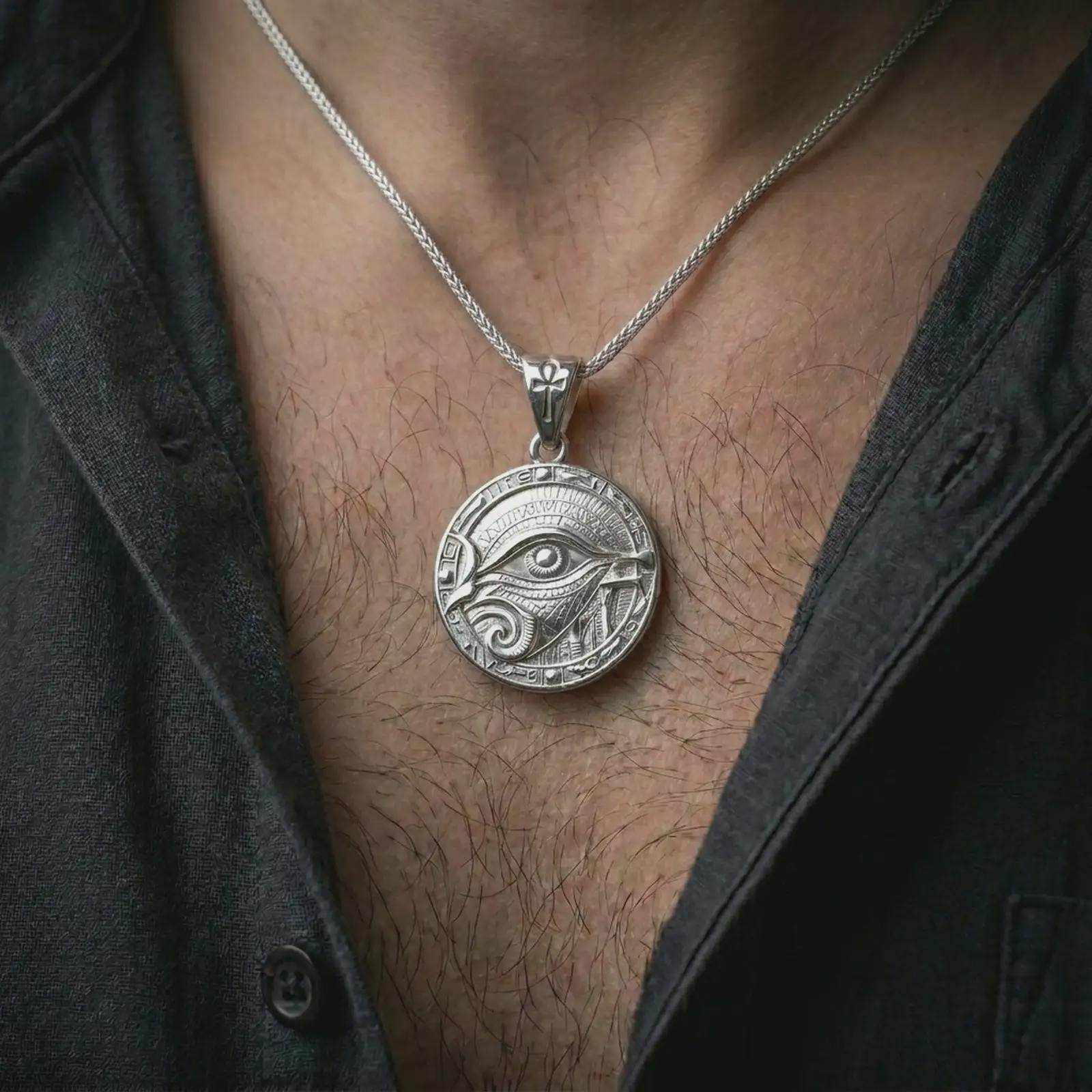 A polished silver Eye of Horus pendant is worn on the neck in a premium close-up lifestyle image, showing the ancient eye motif clearly.