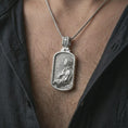 Load image into Gallery viewer, Polished silver Jesus prayer dog tag pendant necklace worn on the chest, masculine lifestyle shot highlighting the side-profile Christ relief, halo, and bright silver finish.
