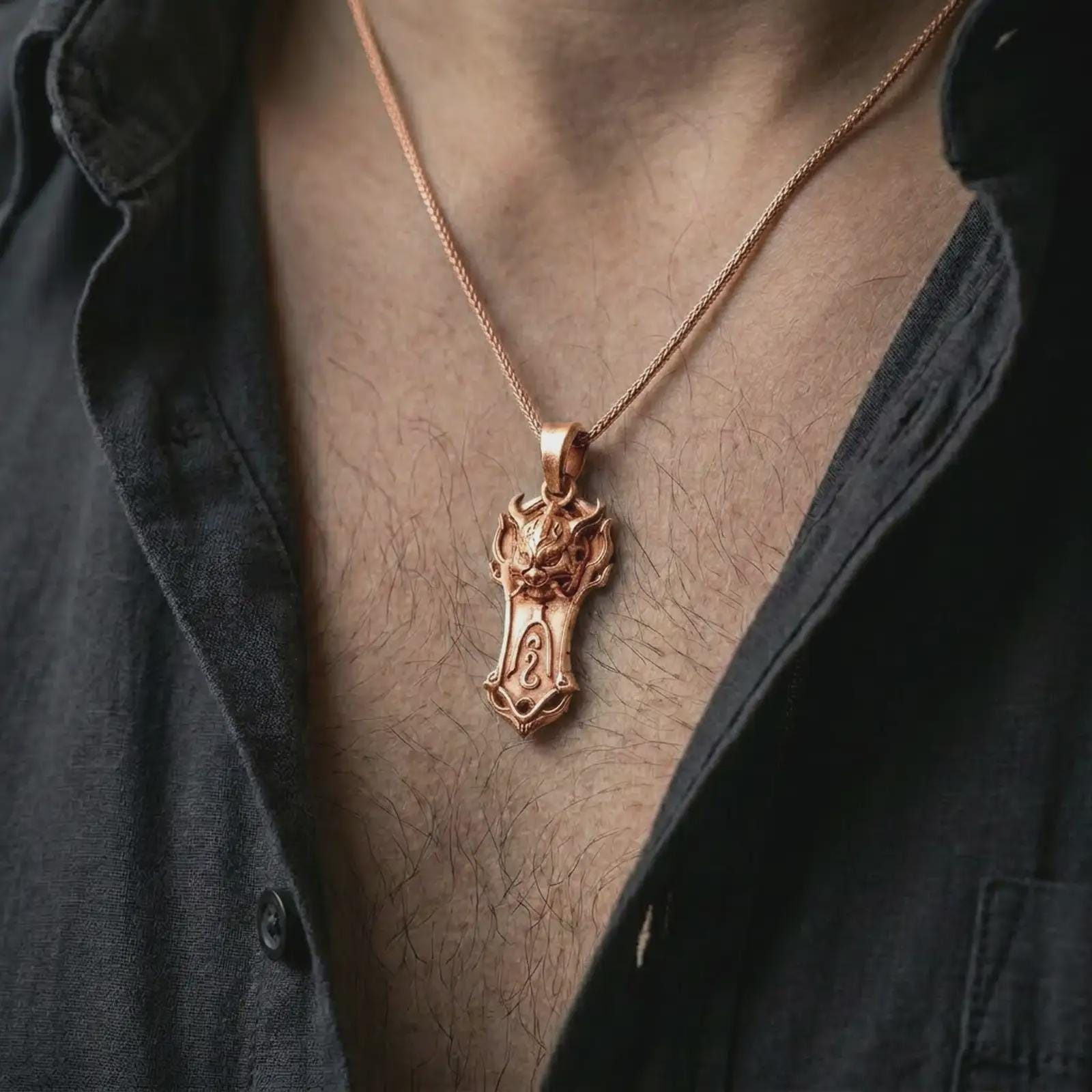 A rose gold plated Taurus bull pendant is worn on the neck in a close-up lifestyle composition, highlighting its shield-like frame and bold bull design.