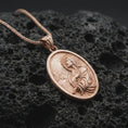 Load image into Gallery viewer, Rose gold plated Jesus Christ prayer pendant necklace on textured volcanic rock, detailed macro product shot with soft warm reflections and devotional Christ symbolism.
