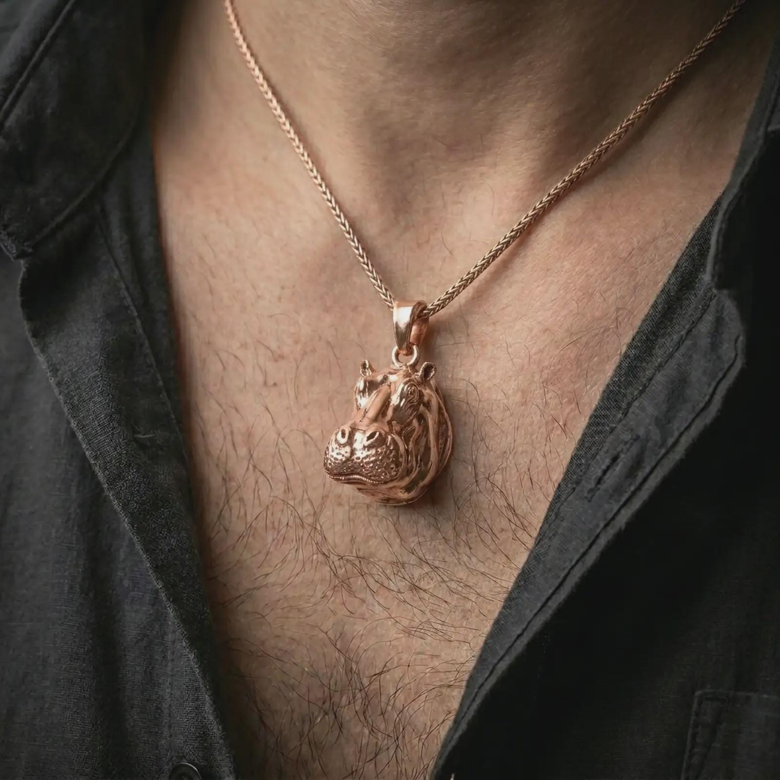 Rose gold plated hippo head pendant necklace worn on the chest, close-up lifestyle shot featuring the detailed hippopotamus charm with warm rose gold tones.