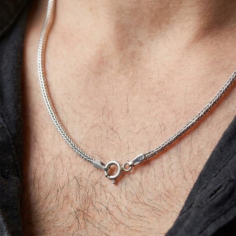 Polished silver Italian foxtail chain necklace worn on the chest, masculine lifestyle shot highlighting the bright silver spiga pattern and clean polished finish.