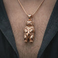 Load image into Gallery viewer, Rose gold plated baby bear pendant necklace worn on the chest, close-up lifestyle shot featuring the adorable baby bear charm with warm rose gold tones.
