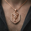 Load image into Gallery viewer, Rose gold plated pharaoh shield pendant necklace worn on the chest, close-up lifestyle shot featuring the pharaoh shield design with warm rose gold tones.
