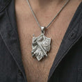 Load image into Gallery viewer, Polished silver crusader pendant worn on the chest, premium lifestyle framing with the pendant centered and in focus.
