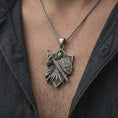 Load image into Gallery viewer, Oxidized knight pendant worn on the neck on a spiga-style chain, close-up lifestyle crop with dark outfit and soft shadows.
