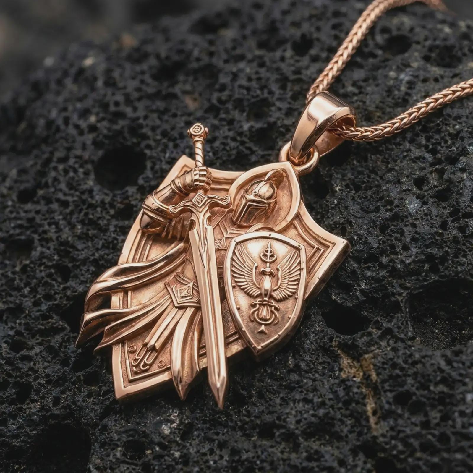 Rose gold plated medieval warrior pendant on volcanic stone, cinematic macro lighting highlighting the raised armor lines.