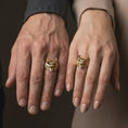 Load image into Gallery viewer, Gold plated owl ring worn on a finger in a close-up lifestyle frame, showcasing the bold signet profile.
