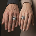 Load image into Gallery viewer, Polished sterling silver owl ring worn on a finger in a tight macro lifestyle composition, emphasizing the sculpted owl face.
