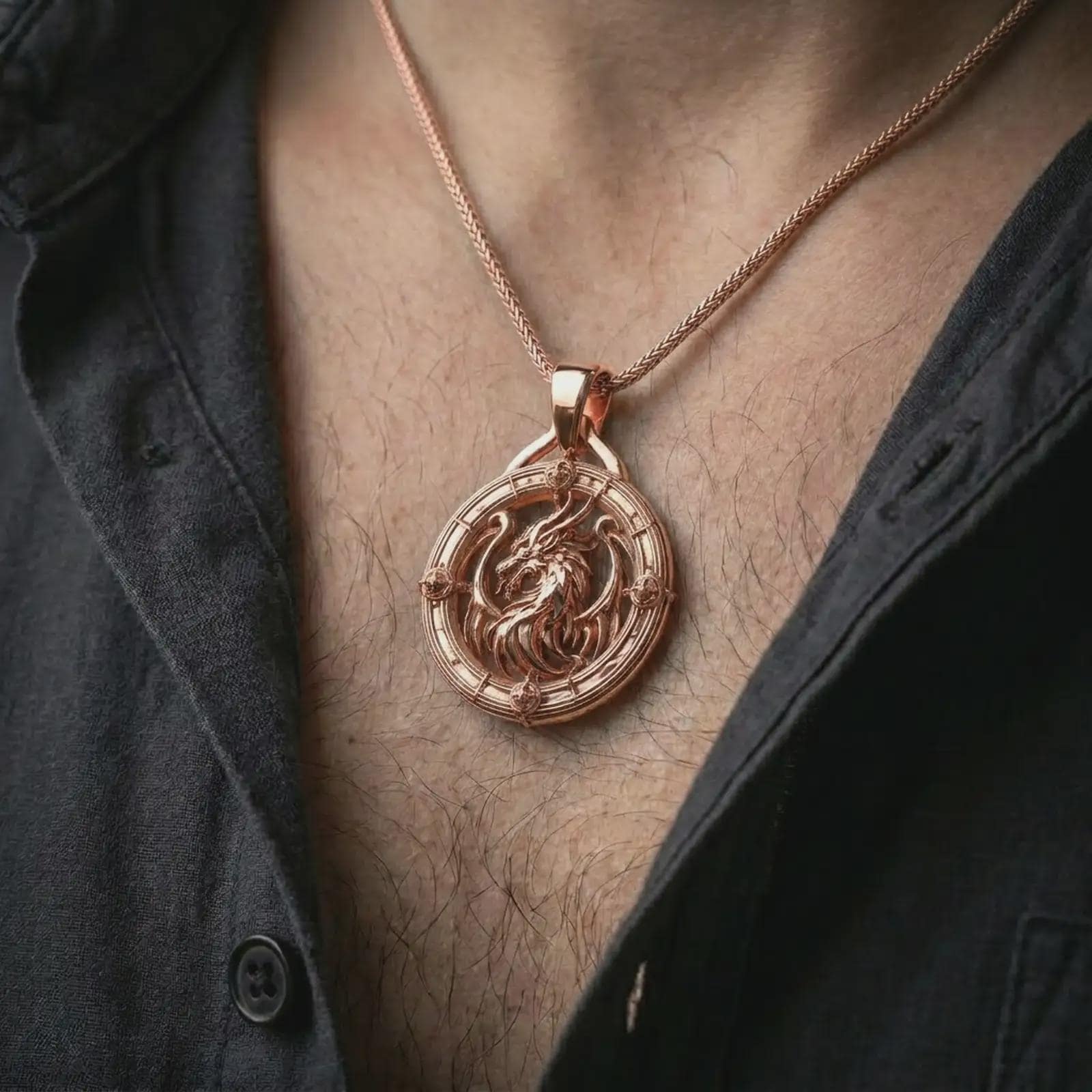 A rose gold plated dragon pendant is worn on the neck in a close-up lifestyle composition, highlighting its mythical dragon detail and bold frame.