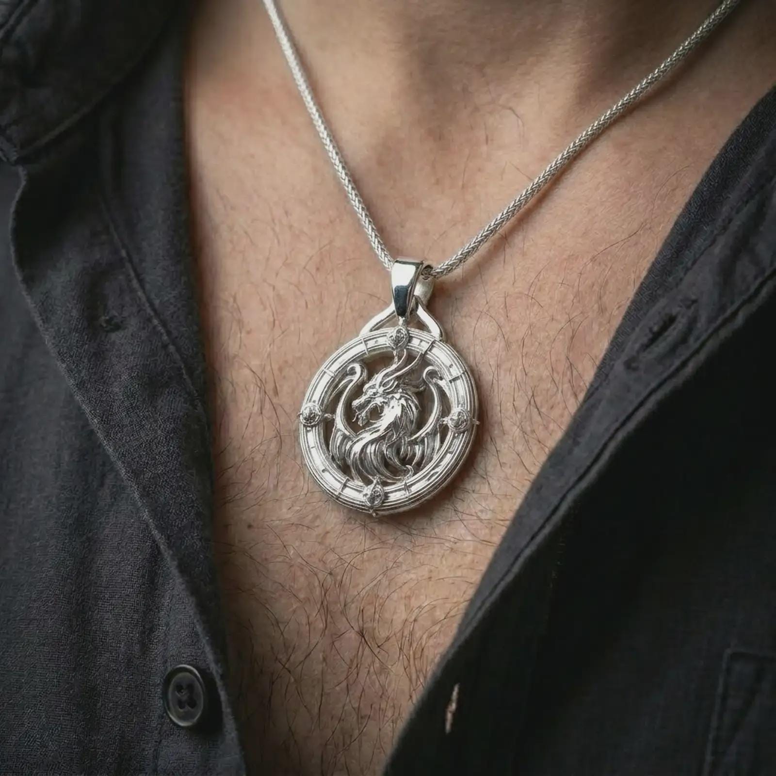 A polished silver dragon pendant is worn on the neck in a premium close-up lifestyle image, showing the detailed dragon motif clearly.