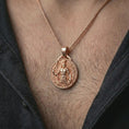 Load image into Gallery viewer, A rose gold plated Spartan warrior pendant is worn on the neck in a close-up lifestyle composition, highlighting its laurel frame and warrior detail.
