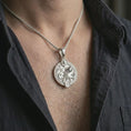 Load image into Gallery viewer, Polished silver Aquarius zodiac pendant necklace worn on the chest, masculine lifestyle shot highlighting the water bearer design, wave detail, and bright silver finish.
