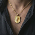 Load image into Gallery viewer, Gold plated double-headed eagle shield pendant necklace worn on the chest, premium lifestyle jewelry photo with the Shqiponja dykrenare pendant centered on a spiga chain.

