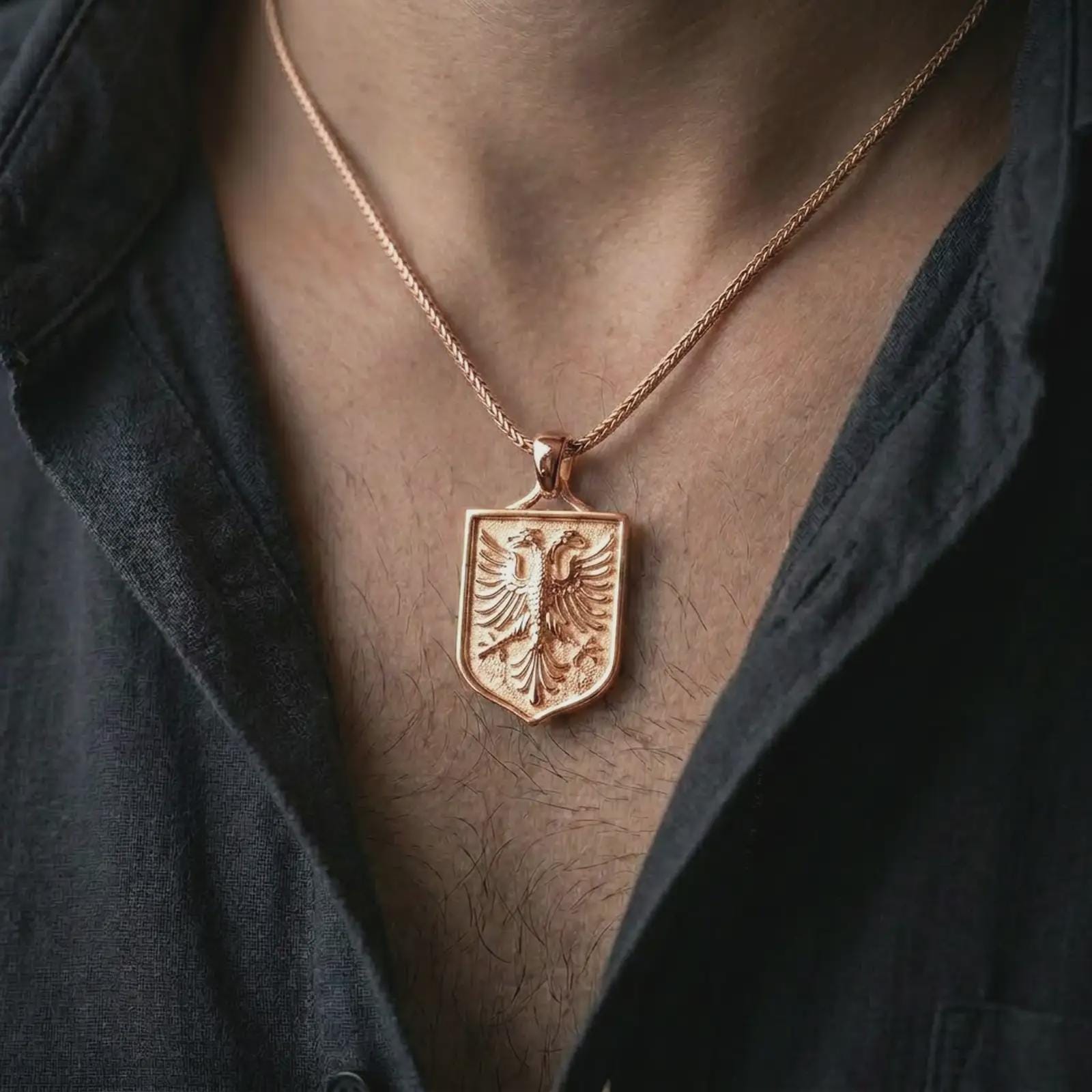 Rose gold plated double-headed eagle shield pendant necklace worn on the chest, close-up lifestyle shot featuring the double-headed eagle crest with warm rose gold tones.
