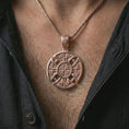 Load image into Gallery viewer, Rose gold plated Celtic cross pendant necklace worn on the chest, close-up lifestyle shot featuring the intricate Norse knotwork cross design with warm rose gold tones.
