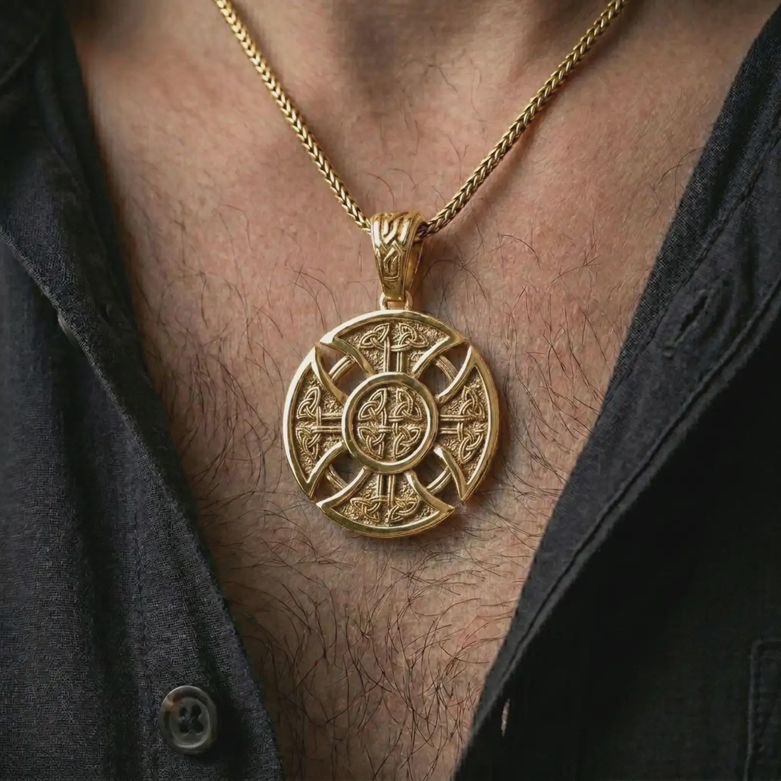 Gold plated Celtic cross pendant necklace worn on the chest, premium lifestyle jewelry photo with the round Celtic cross pendant centered on a spiga chain.