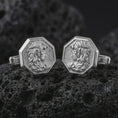 Load image into Gallery viewer, Polished silver Medusa cufflinks are displayed on black volcanic rock in a premium macro studio close-up with detailed Greek mythology texture.
