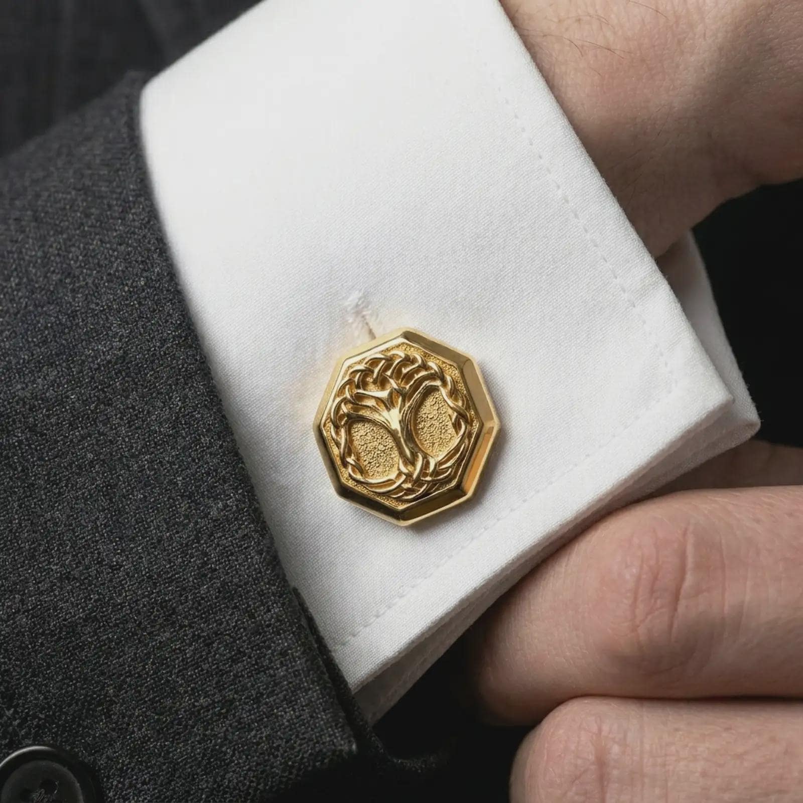 A gold plated Yggdrasil cufflink is worn on a white cuff in a close-up lifestyle shot, styled as a distinctive Viking wedding gift for men.
