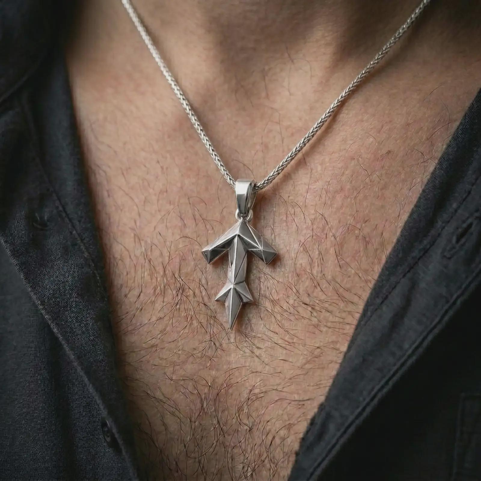 A polished silver Tyr rune pendant is worn on the neck in a premium close-up lifestyle image, showing the Teiwaz rune clearly.
