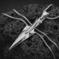 Load image into Gallery viewer, A polished silver Gungnir pendant is displayed on black volcanic rock in a premium macro studio close-up with clean angular lines and bold spear detail.
