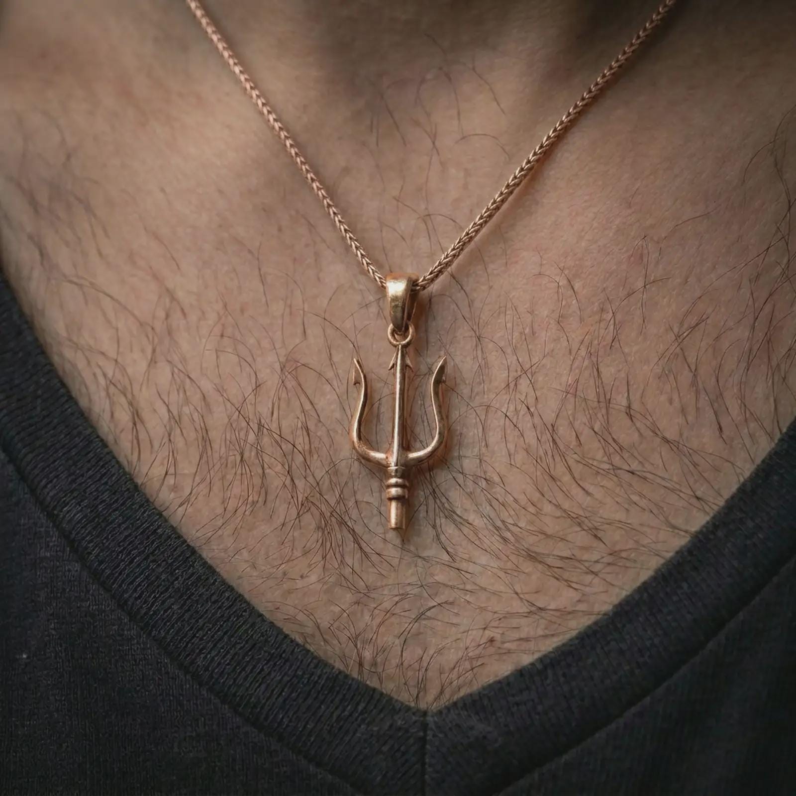 Rose gold plated Poseidon trident pendant necklace worn on the chest, close-up lifestyle shot featuring the Greek Poseidon trident design with warm rose gold tones.