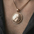 Load image into Gallery viewer, Rose gold plated Spartan shield pendant necklace worn on the chest, close-up lifestyle shot featuring the battle-worn Spartan shield design with warm rose gold tones.
