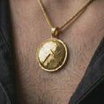 Load image into Gallery viewer, Gold plated Spartan shield pendant necklace worn on the chest, premium lifestyle jewelry photo with the Greek warrior shield pendant centered on a spiga chain.
