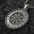 Load image into Gallery viewer, Oxidized Vegvisir Viking rune pendant necklace on textured volcanic rock, close-up studio shot highlighting the Norse compass symbol, rune border, rope frame, and antique silver contrast.
