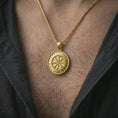 Load image into Gallery viewer, Gold plated Vegvisir Viking rune pendant necklace worn on the chest, premium lifestyle jewelry photo with the Viking protection pendant centered on a spiga chain.
