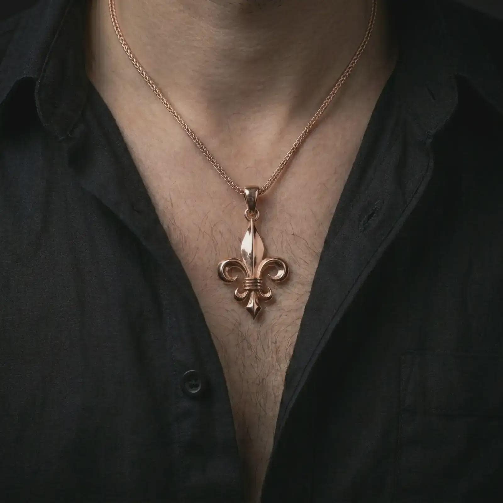 Rose gold plated fleur-de-lis pendant necklace worn on the chest, close-up lifestyle shot featuring the elegant fleur-de-lis design with warm rose gold tones.