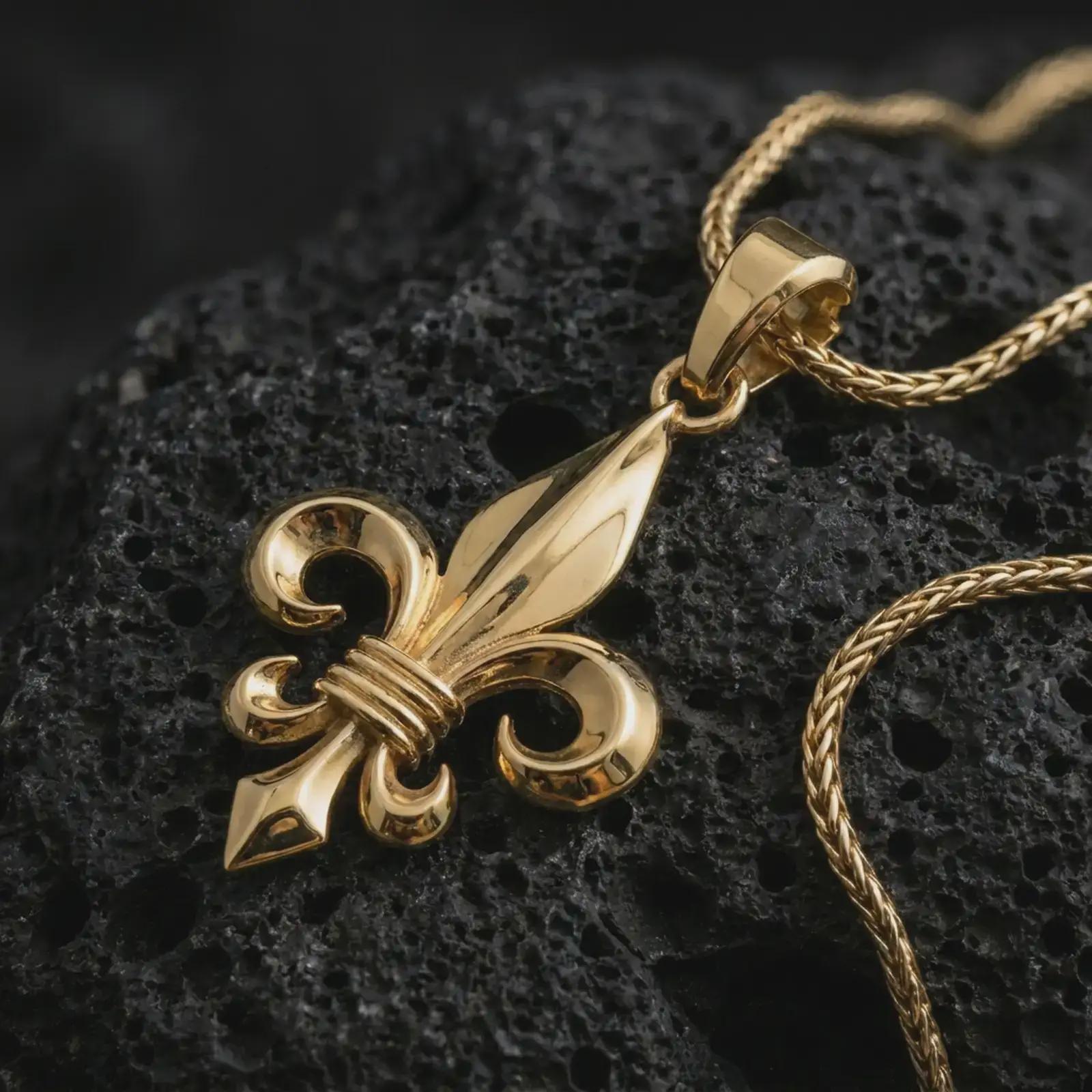 Gold plated fleur-de-lis pendant necklace on textured volcanic rock, premium close-up studio composition emphasizing the royal heraldic symbol, medieval silhouette, and elegant amulet design.