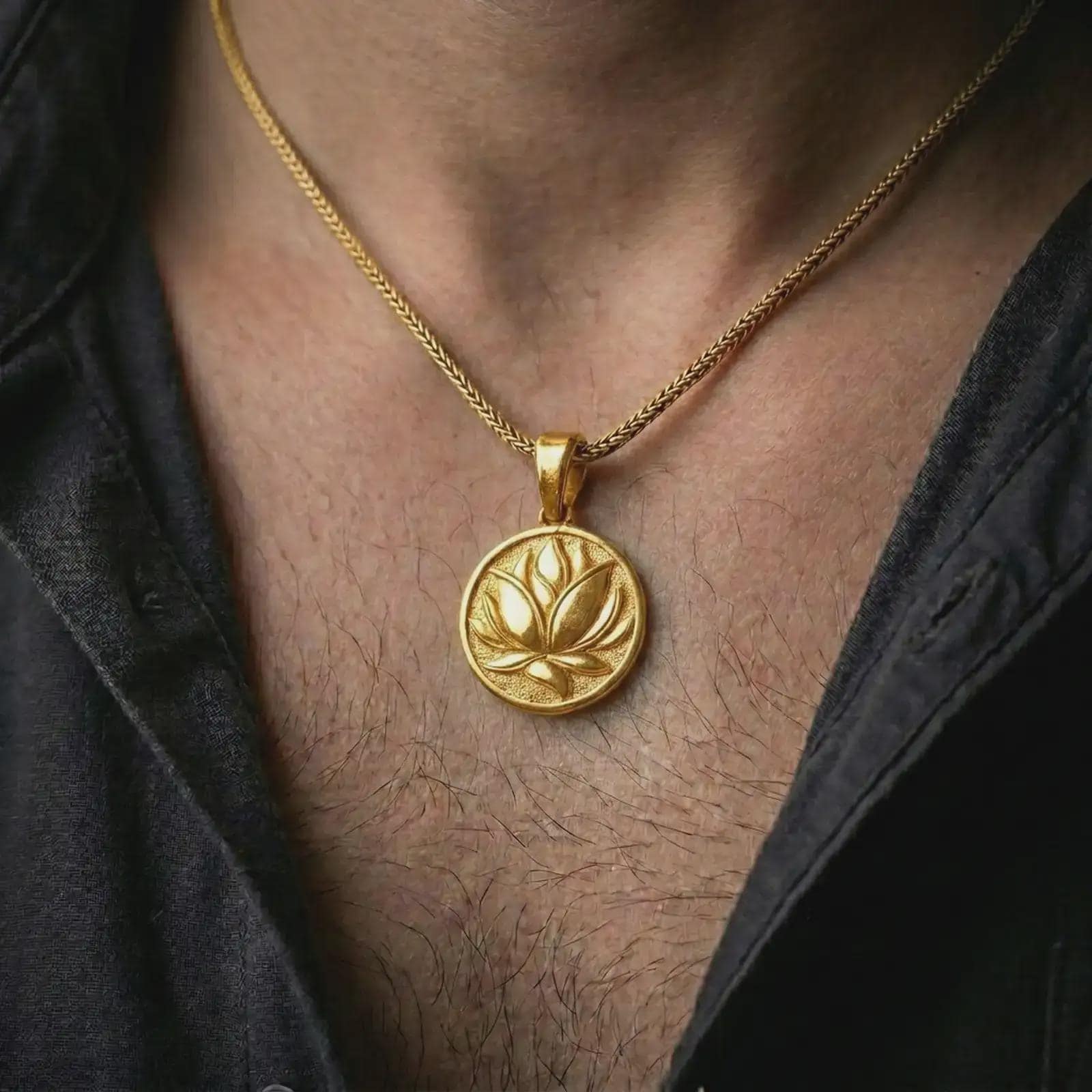 Gold plated lotus flower pendant necklace worn on the chest, premium lifestyle jewelry photo with the yoga-inspired lotus pendant centered on a spiga chain.
