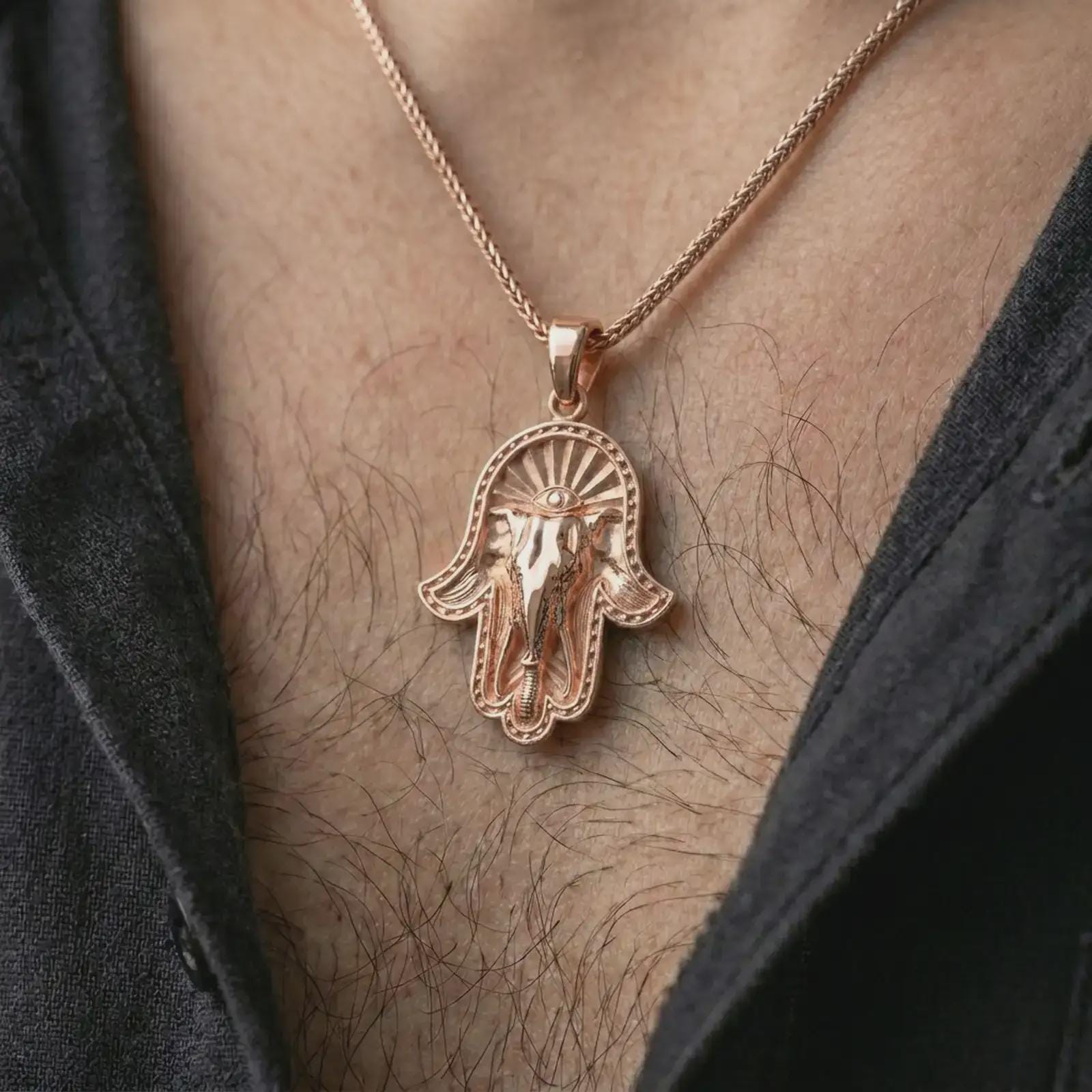 Rose gold plated hamsa elephant pendant necklace worn on the chest, close-up lifestyle shot featuring the sacred elephant hand design with warm rose gold tones.
